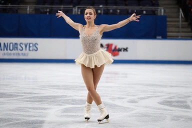 Figure skater in an elegant pose on ice, performing a spin with grace and precision, dressed in a sparkling costume.